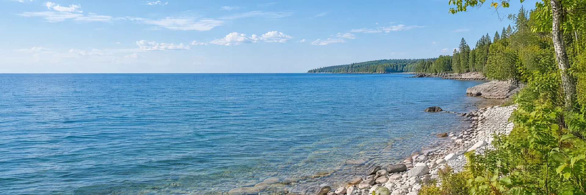 Illustration inspired by Algoma, WI: wisconsin Lake Michigan shoreline, broad blue water, rounded pale beach stones and low leafy coastal woodland.