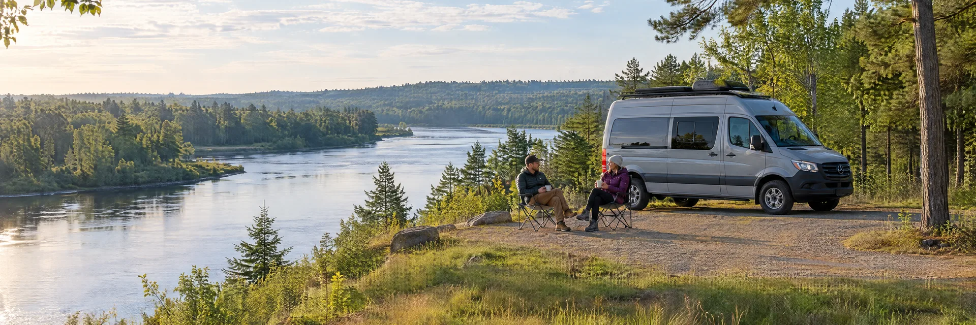 Illustration of campers enjoying morning coffee beside a camper van in a fictional camping setting inspired by Stevens Point, WI.