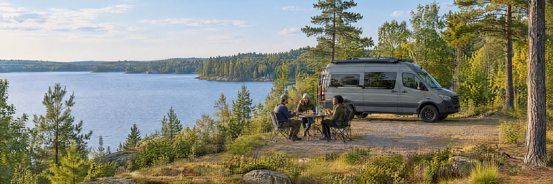 Illustration of campers enjoying an outdoor meal beside a camper van in a fictional camping setting inspired by Wild Rose, WI.