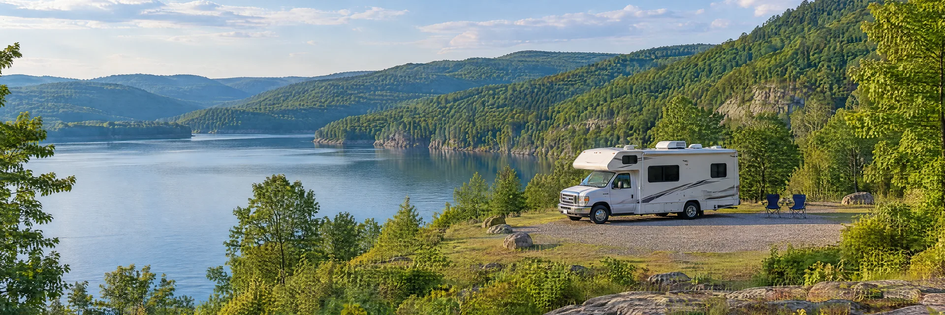 Illustration of a Class C motorhome at a fictional camping setting inspired by Beckley, WV.