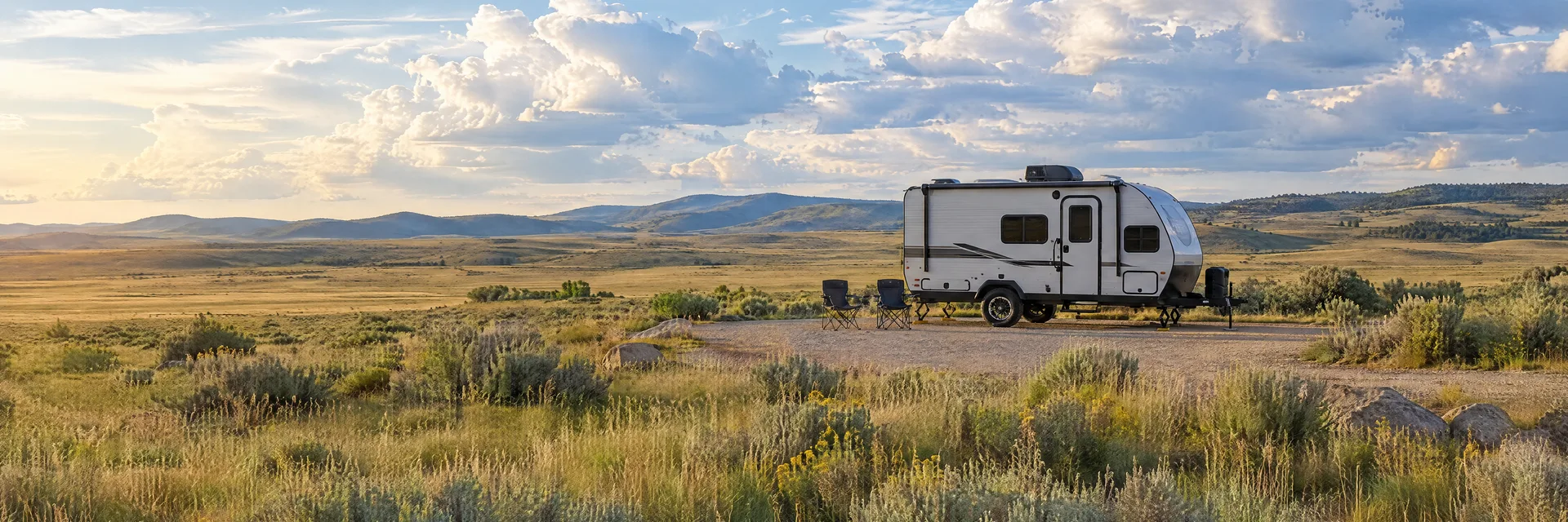 Illustration of a compact travel trailer at a fictional camping setting inspired by El Rancho, WY.