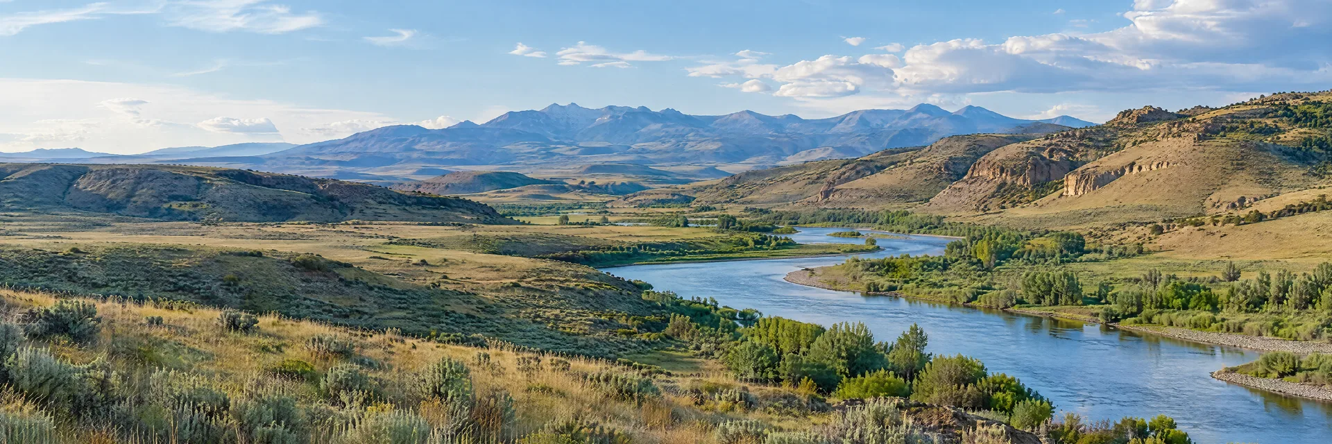 Illustration inspired by Evanston, WY: high Wyoming grassland, sagebrush and low dry ridges around a winding river.