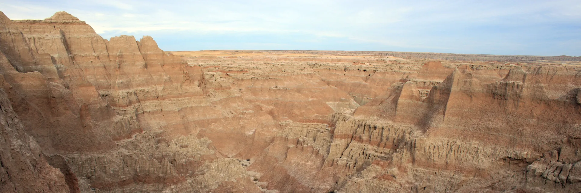Layered, eroded rock formations in Badlands National Park.