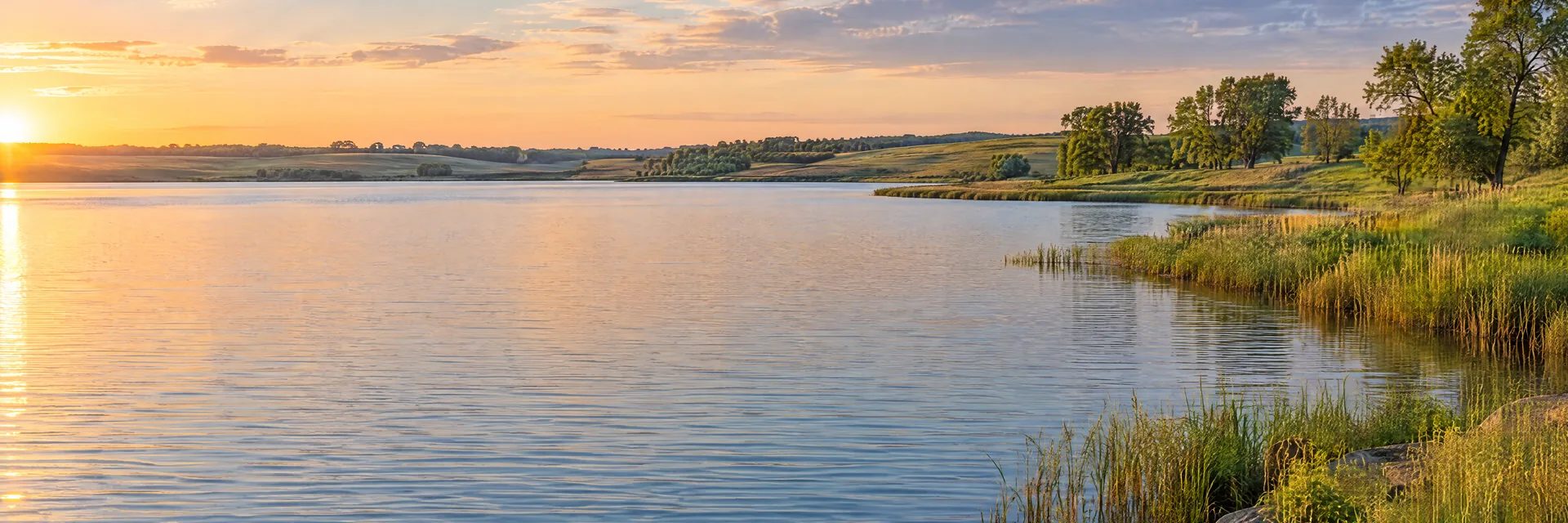 AI-generated illustration inspired by Big Stone Lake: broad prairie lake, low grassy rolling banks, scattered deciduous trees.