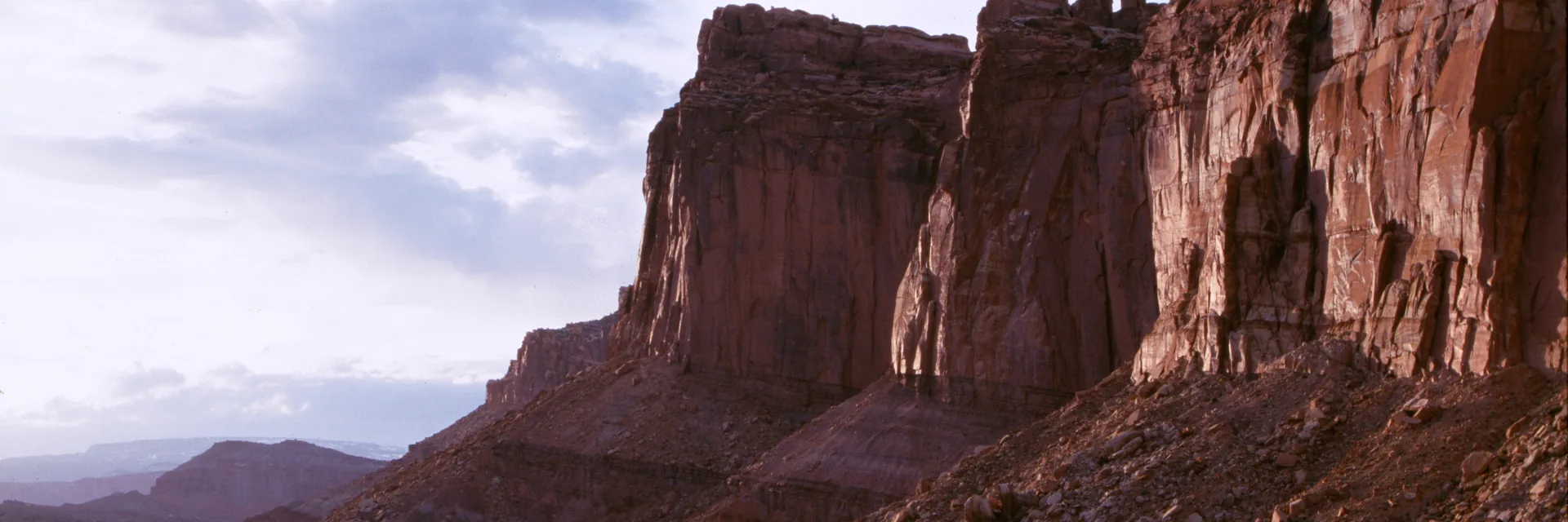 Red sandstone cliffs above the green Fruita valley in Capitol Reef National Park.