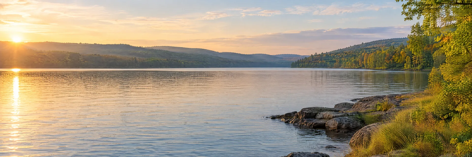 AI-generated illustration inspired by Chautauqua Lake: northeastern freshwater lake with rolling wooded hills, mixed deciduous forest, natural rocky and grassy banks.