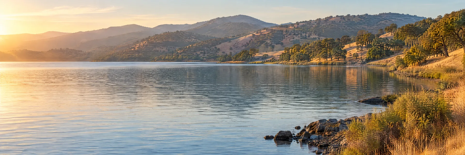 AI-generated illustration inspired by Clear Lake: broad northern California lake, oak-covered rounded hills, dry golden grass.
