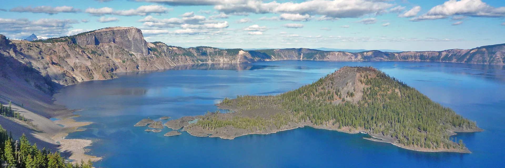 Blue Crater Lake and Wizard Island beneath the surrounding caldera rim.