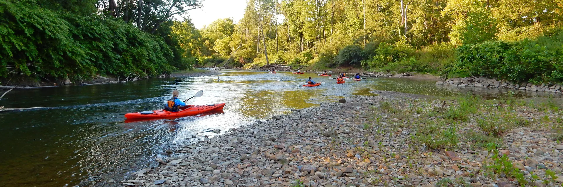 Kayakers on a wooded bend of the Cuyahoga River in Cuyahoga Valley National Park.