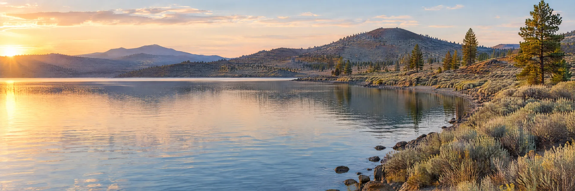AI-generated illustration inspired by Eagle Lake: northeastern California high plateau lake, dry sagebrush banks with sparse ponderosa pine and low volcanic hills.