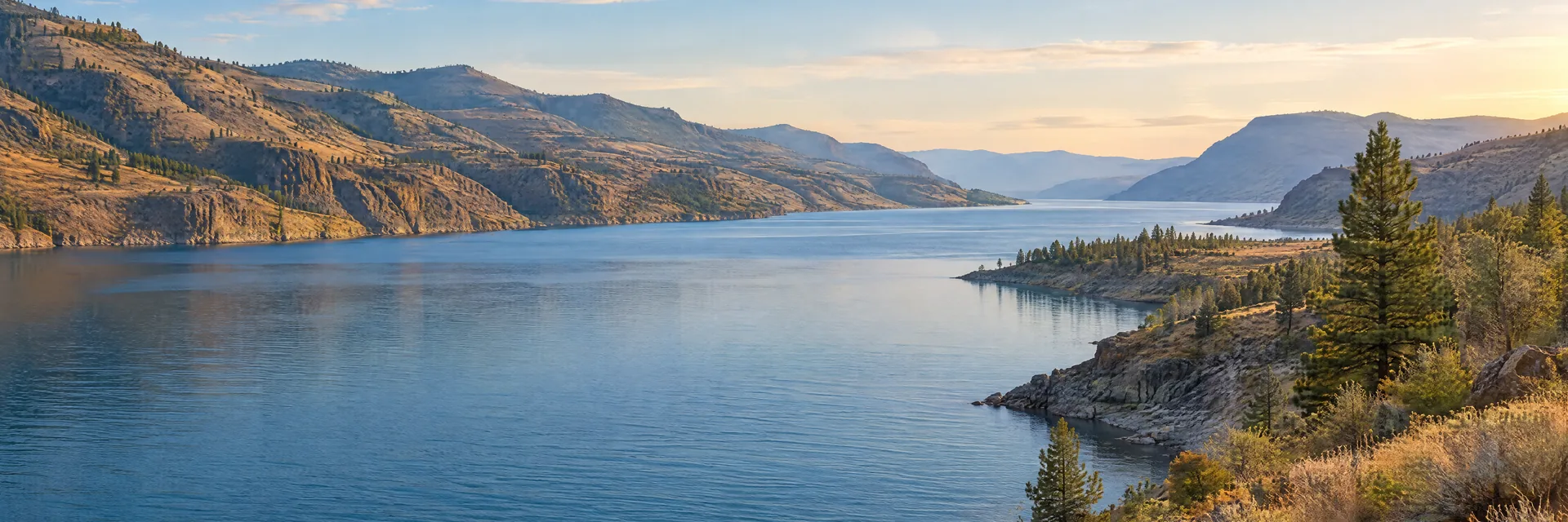 AI-generated illustration inspired by Franklin D. Roosevelt Lake: Columbia River reservoir with long blue waterway, dry rocky hills and scattered pines.