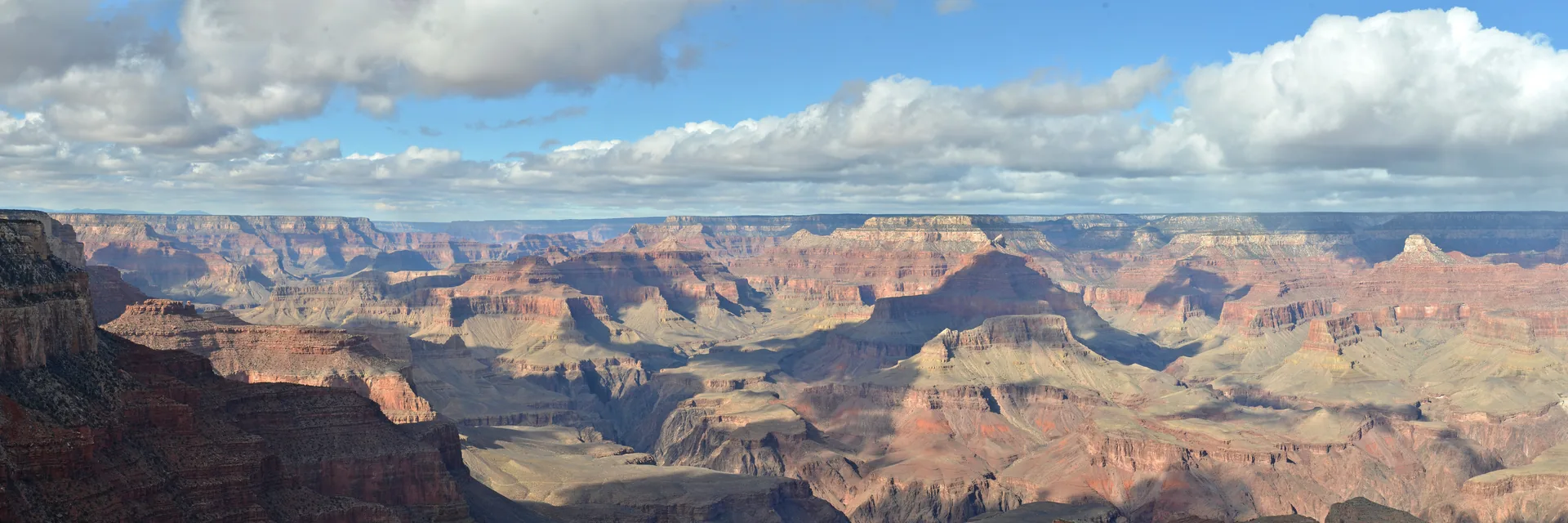Layered canyon walls beneath a cloudy sky in Grand Canyon National Park.
