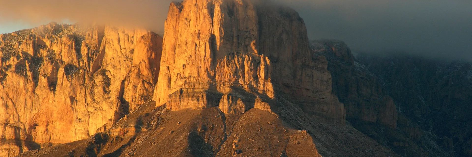 Warm sunlight on El Capitan beneath low clouds in Guadalupe Mountains National Park.