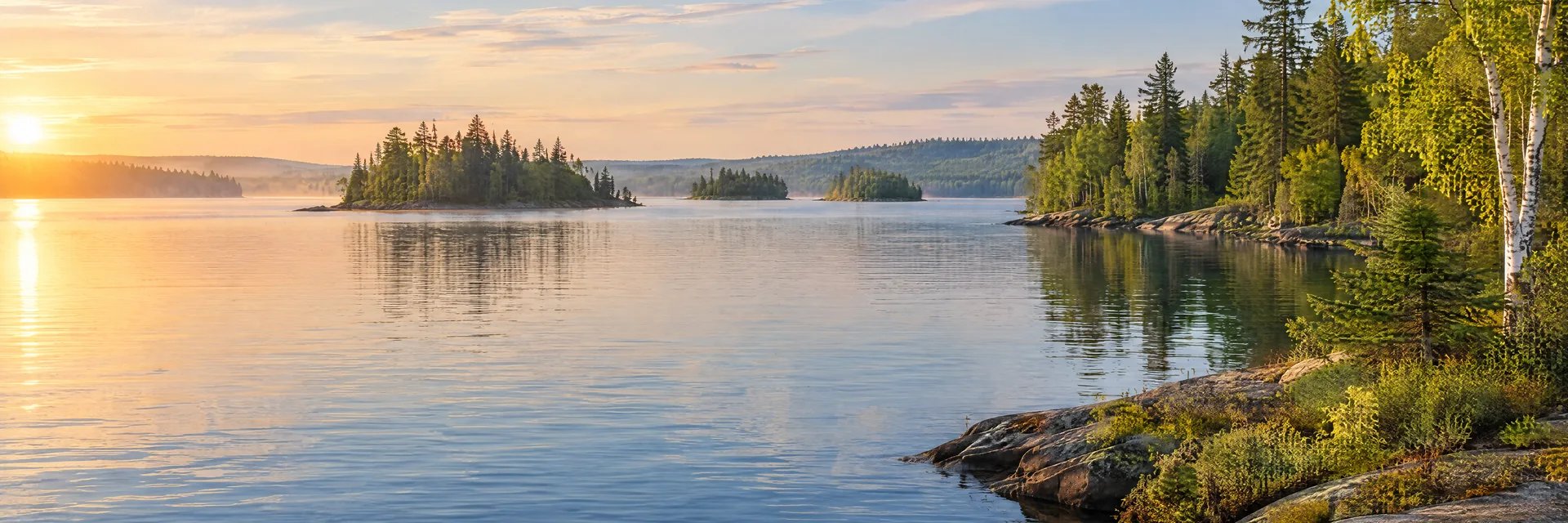 AI-generated illustration inspired by Lake Chippewa: northern freshwater lake, low rocky shoreline with evergreen and birch forest, small wooded islands and gentle rolling terrain.