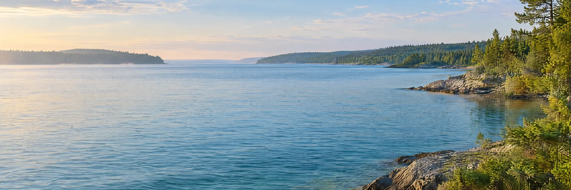 AI-generated illustration inspired by Lake Michigan–Huron: Straits of Mackinac regional lake landscape, broad open blue freshwater and low forested shores.