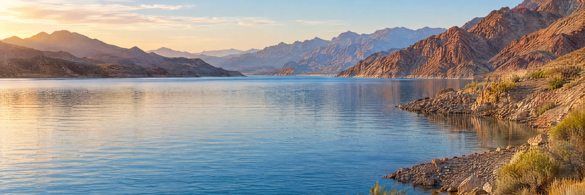 AI-generated illustration inspired by Lake Mohave: long desert reservoir, blue water, rugged brown and rust-colored rocky mountains.