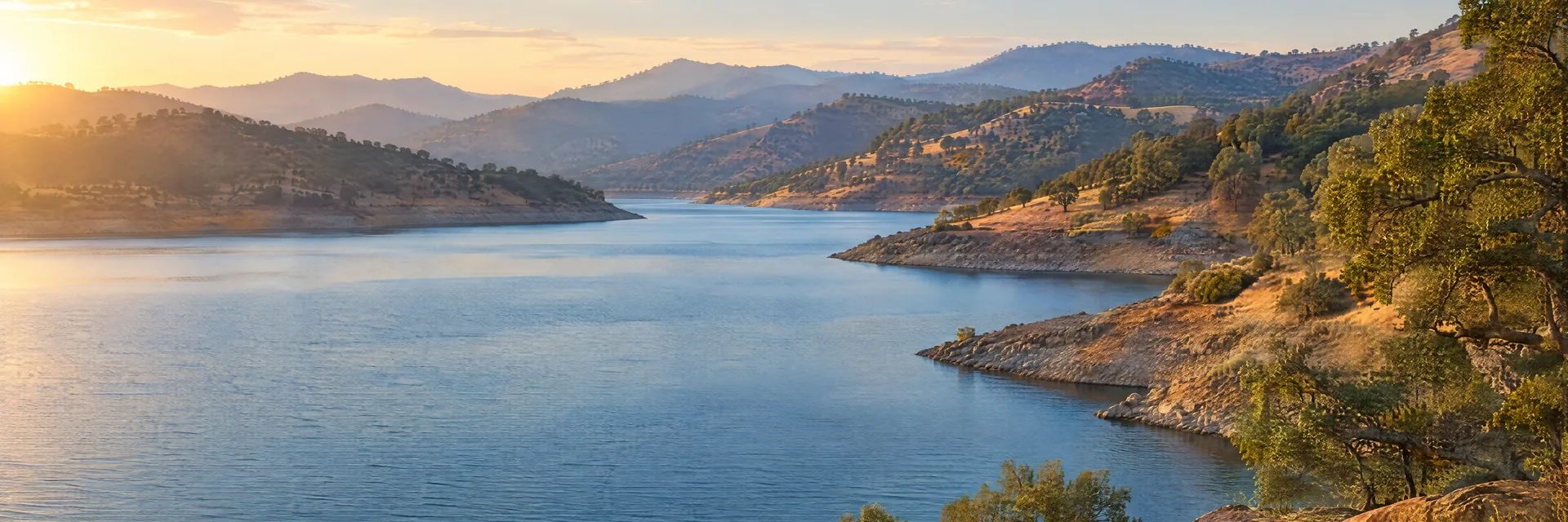 AI-generated illustration inspired by Lake Oroville: California branching reservoir, dry foothills and oak woodlands.