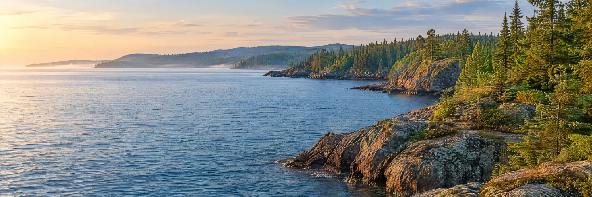 AI-generated illustration inspired by Lake Superior: rugged Great Lakes shoreline, pine forest, rock outcrops and expansive deep blue water.