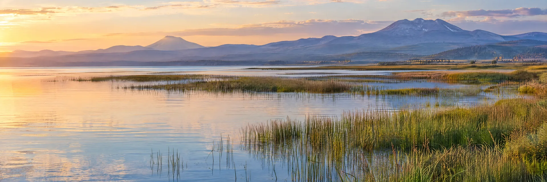 AI-generated illustration inspired by Upper Klamath Lake: large shallow Oregon lake with marshy reeds, broad open water and distant volcanic uplands.