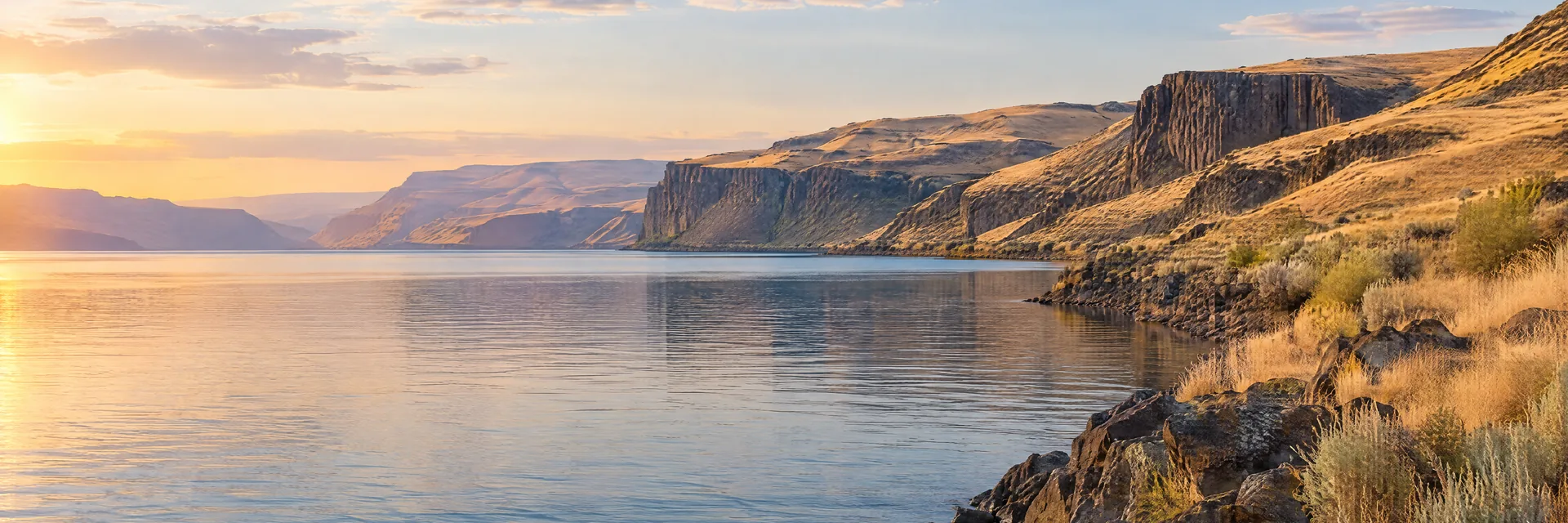 AI-generated illustration inspired by Wanapum Lake: Columbia River reservoir with dry basalt cliffs and tawny grass-covered hills.