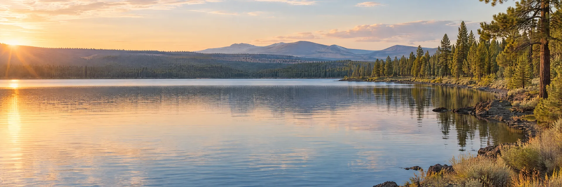AI-generated illustration inspired by Wickiup Reservoir: central Oregon reservoir, lodgepole and ponderosa pines, flat volcanic plateau and distant low Cascade uplands.