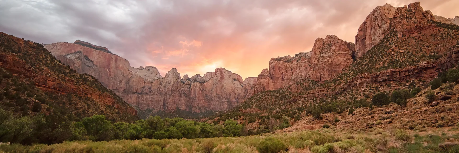 Red and white sandstone towers at sunset in Zion National Park.
