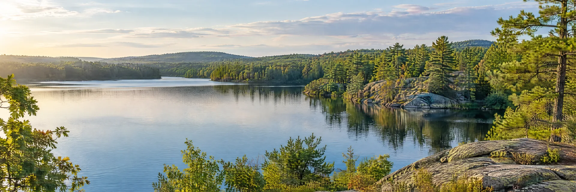 Illustration of representative natural scenery in Massachusetts: new England wooded pond, granite outcrops and mixed oak-pine forest.