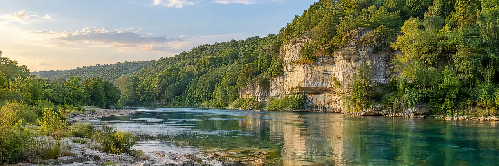 Illustration of representative natural scenery in Missouri: ozark clear river, pale limestone bluffs and dense hardwood forest.