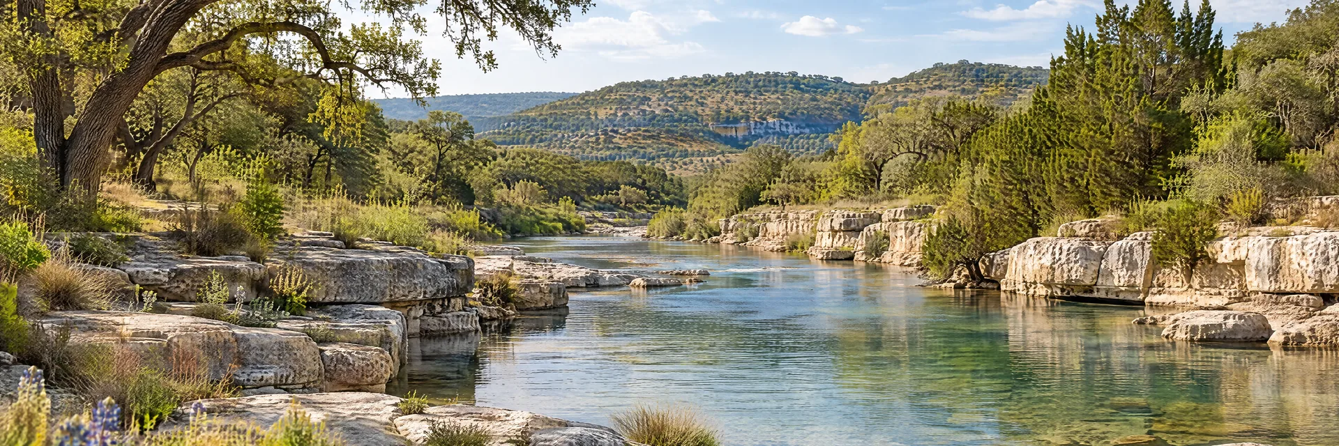 AI-generated illustration inspired by Texas: Texas Hill Country, clear shallow river beside pale limestone ledges, live oak and juniper trees on low rolling hills.